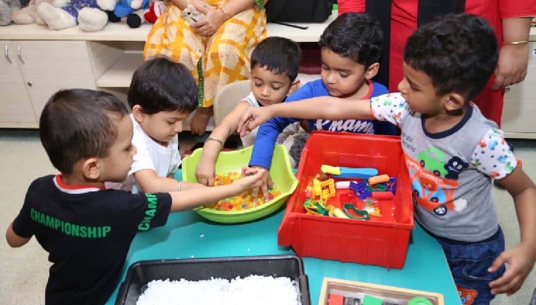 Preschool children enjoying sensory play.